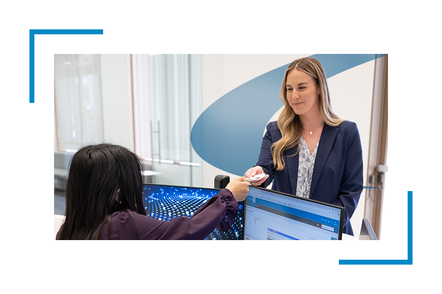 Two women exchanging cards