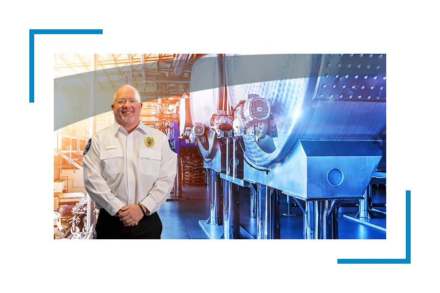 Smiling Allied universal security professional near an industrial equipment