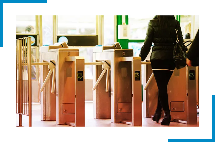 Woman walking through turnstile 