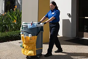 woman walking with trash can, janitorial services